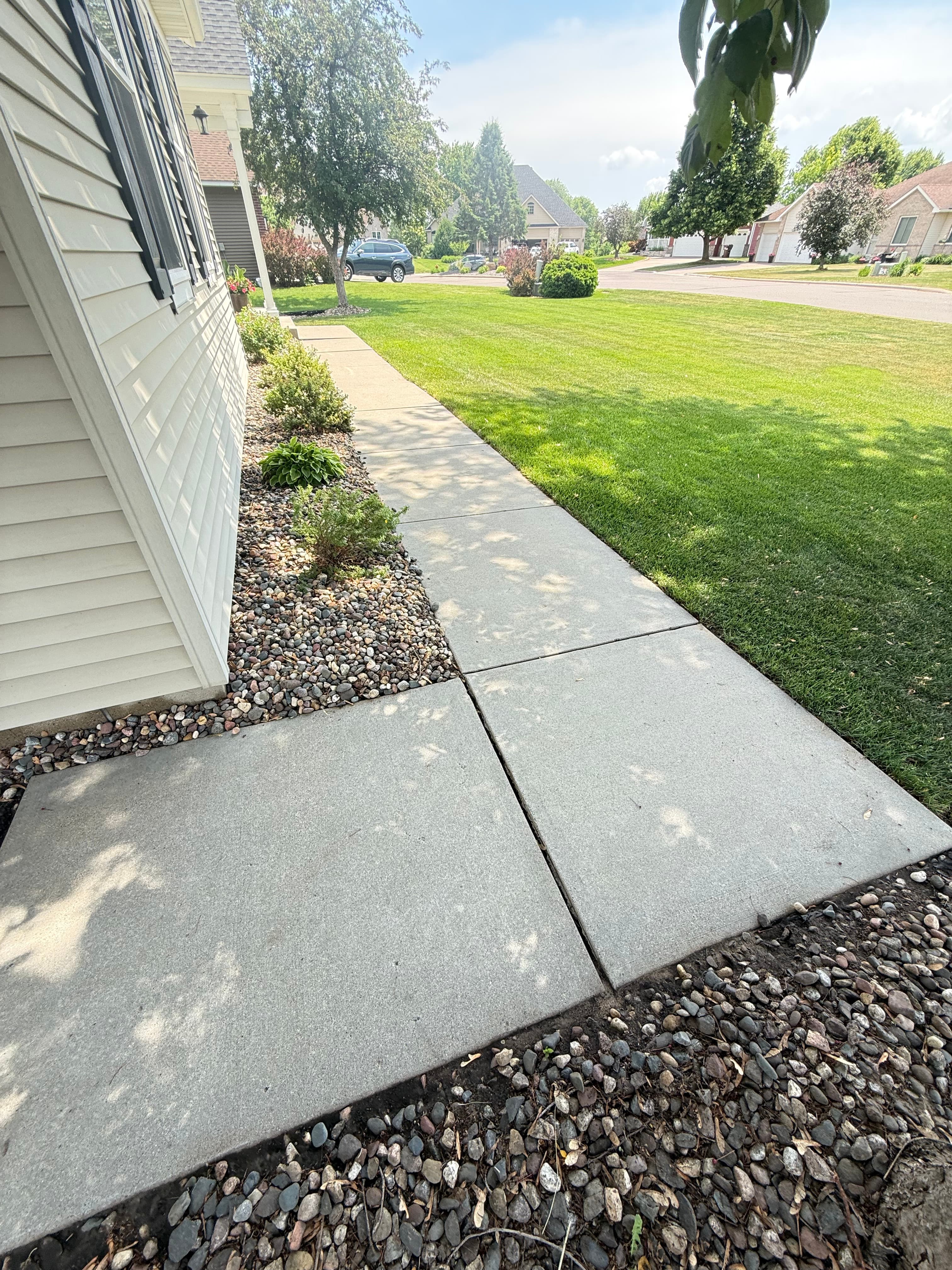 Clean concrete walkway after pressure washing